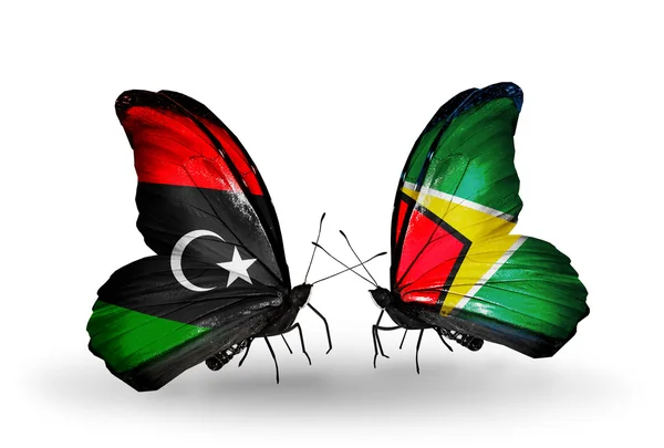 Libya ve Guyana bayrakları taşıyan kelebekler — Stok fotoğraf