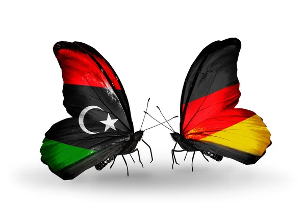 Borboletas com bandeiras da Líbia e da Alemanha — Fotografia de Stock