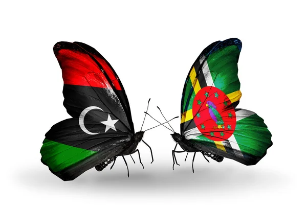 Butterflies with  Libya and Dominica flags — Stock Photo, Image