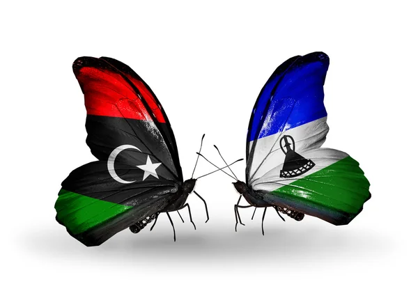 Fjärilar med Libyen och Lesotho flaggor — Stockfoto