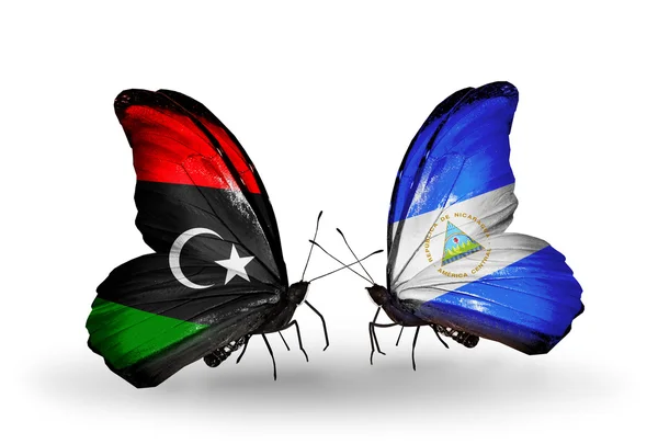 Schmetterlinge mit libyschen und nicaraguanischen Flaggen — Stockfoto