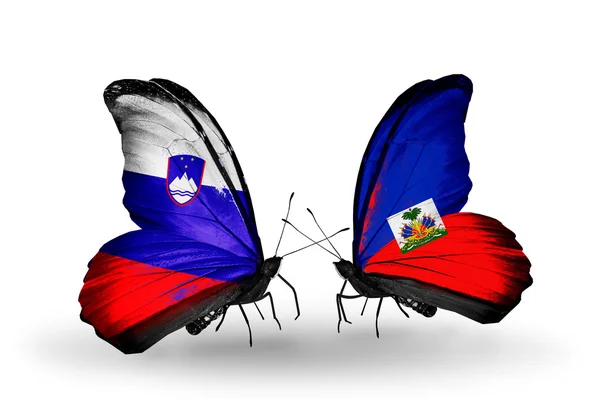 Butterflies with Slovenia and Haiti flags — Stock Photo, Image