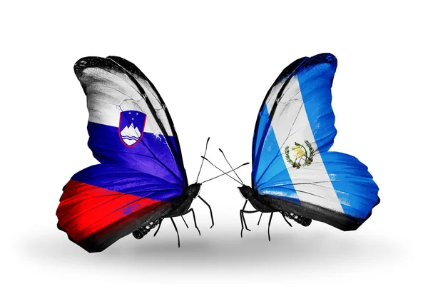 Butterflies with Slovenia and Guatemala flags — Stock Photo, Image