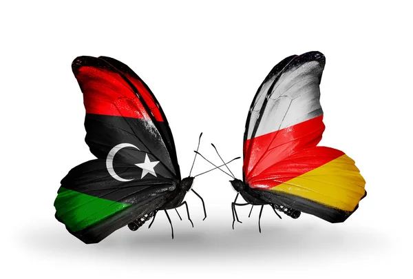 Borboletas com bandeiras da Líbia e da Ossétia do Sul — Fotografia de Stock