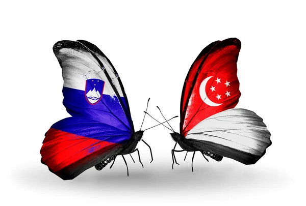 Butterflies with Slovenia and Singapore flags — Stock Photo, Image