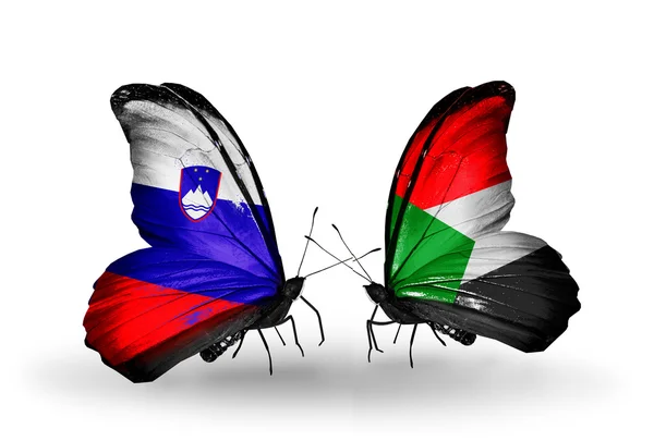 Butterflies with Slovenia and Sudan flags — Stock Photo, Image