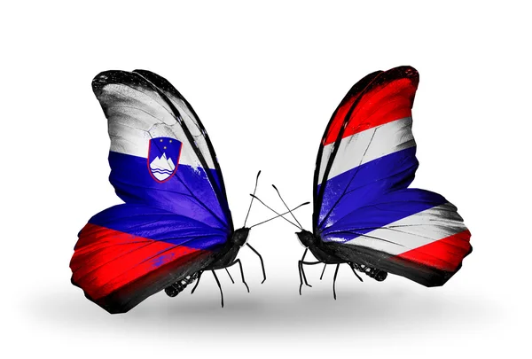 Butterflies with  Slovenia and Thailand flags — Stock Photo, Image