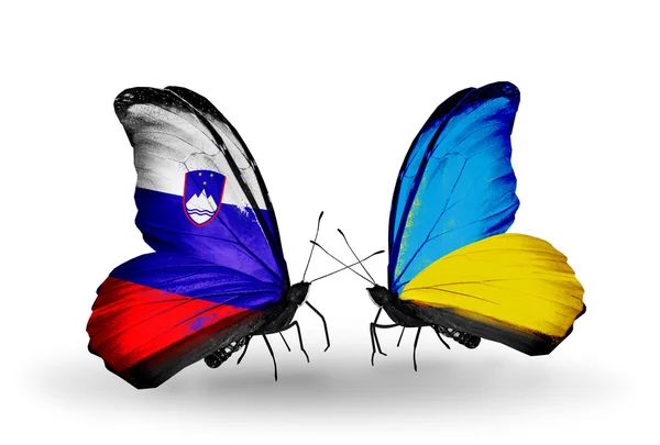 Butterflies with Slovenia and Ukraine flags — Stock Photo, Image
