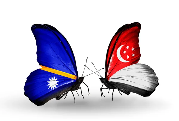 Butterflies with Nauru and Singapore flags — Stock Photo, Image