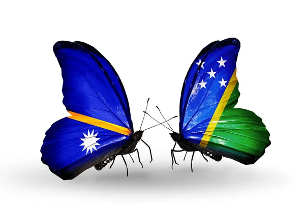 Butterflies with Nauru and Solomon Islands flags — Stock Photo, Image