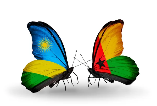 Butterflies with Rwanda and Guinea Bissau flags — Stock Photo, Image