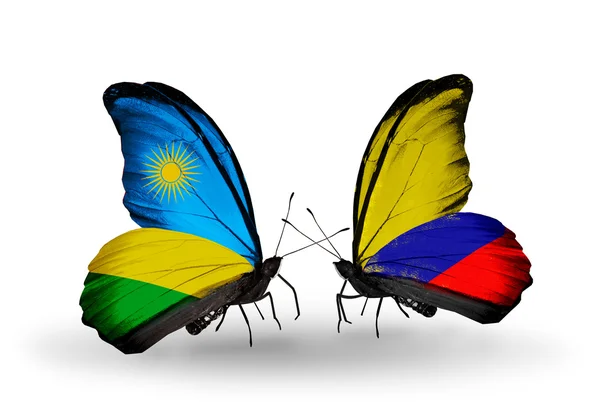 Butterflies with Rwanda and Columbia flags — Stock Photo, Image