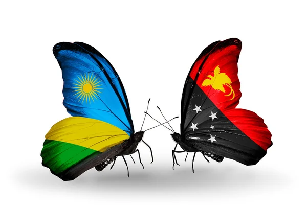 Schmetterlinge mit Ruanda und Papua-Neuguinea-Flagge — Stockfoto