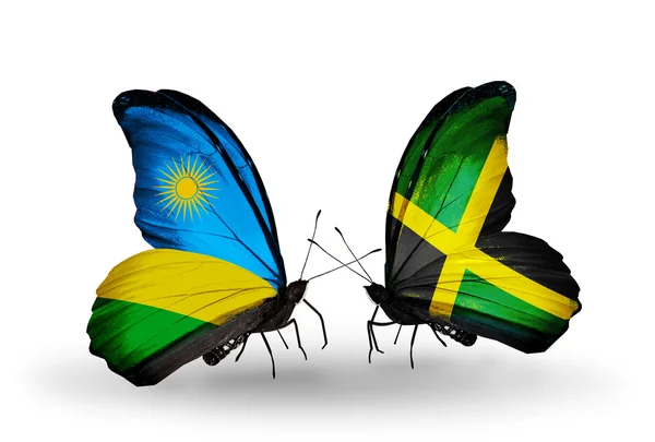 Butterflies with Rwanda and Jamaica flags — Stock Photo, Image