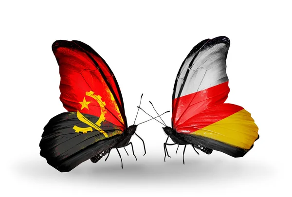 Butterflies with Angola and South Ossetia flags — Stock Photo, Image