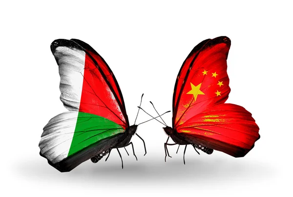 Butterflies with Madagascar and China flags — Stock Photo, Image
