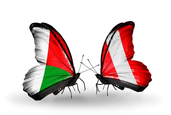 Butterflies with Madagascar and Peru flags — Stock Photo, Image