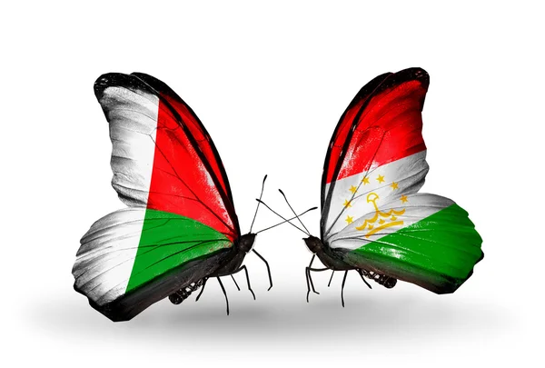 Butterflies with Madagascar and  Tajikistan flags — Stock Photo, Image