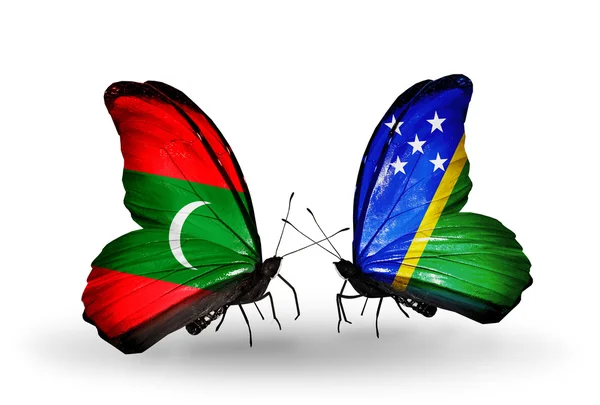 Butterflies with Maldives and Solomon Islands flags — Stock Photo, Image
