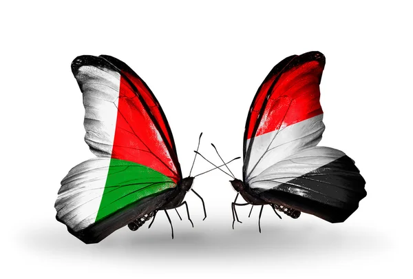 Butterflies with Madagascar and Yemen flags — Stock Photo, Image