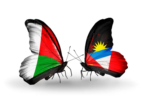 Butterflies with Madagascar and Antigua and Barbuda flags — Stock Photo, Image