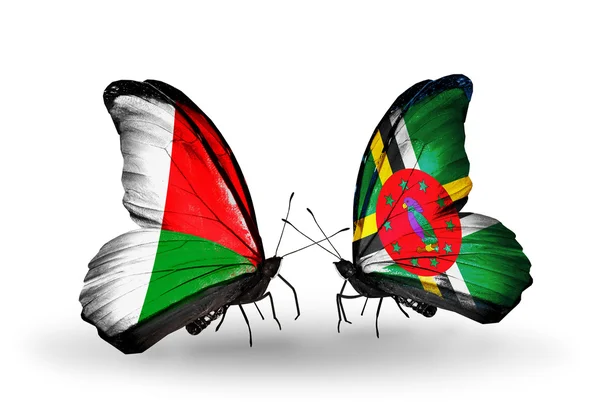 Fjärilar med Madagaskar och Dominica flaggor — Stockfoto
