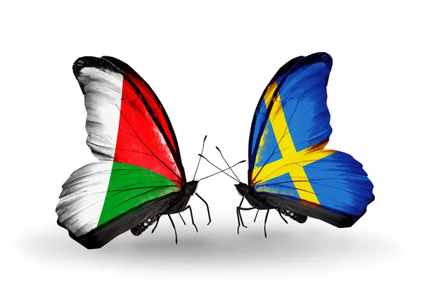 Butterflies with Madagascar and Sweden flags — Stock Photo, Image