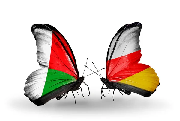 Butterflies with Madagascar and South Ossetia flags — Stock Photo, Image