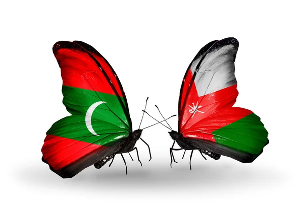 Butterflies with Maldives and Oman flags — Stock Photo, Image