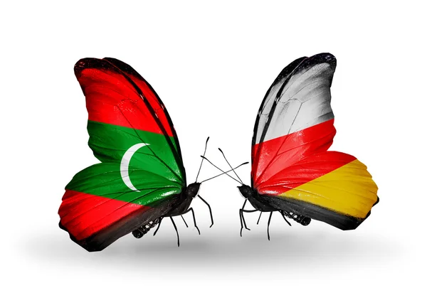 Бабочки с флагами Мальдив и Южной Осетии — стоковое фото