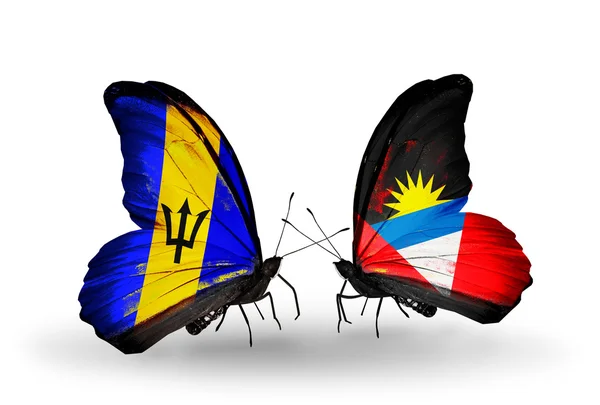 Butterflies with Barbados and Antigua and Barbuda flags — Stock Photo, Image