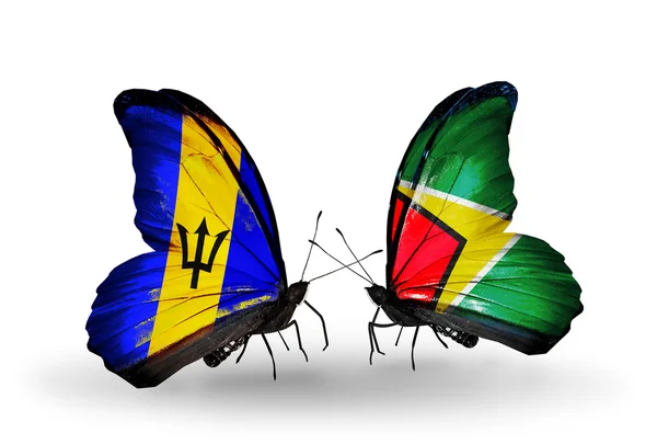 Farfalle con bandiere Barbados e Guyana — Foto Stock