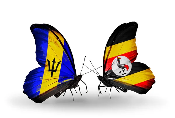 蝴蝶与巴巴多斯和乌干达国旗 — 图库照片