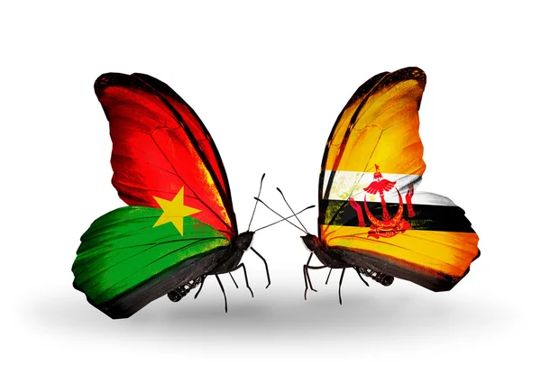 Two butterflies with flags — Stock Photo, Image