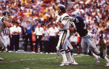 San Diego Chargers QB Dan Fouts sitting on the bench during the 1980's NFL action.  Image taken from a color slide.  clipart