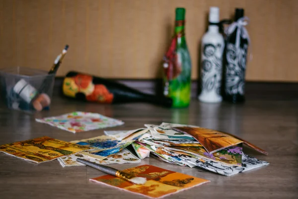 Decoupage napkins lying on the floor .bottles.brush — Stock Photo, Image