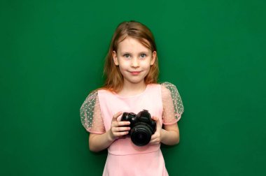 Elinde kamera olan bir kız çocuğu.
