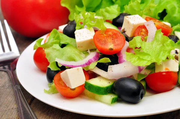 Greek salad and fork — Stock Photo, Image