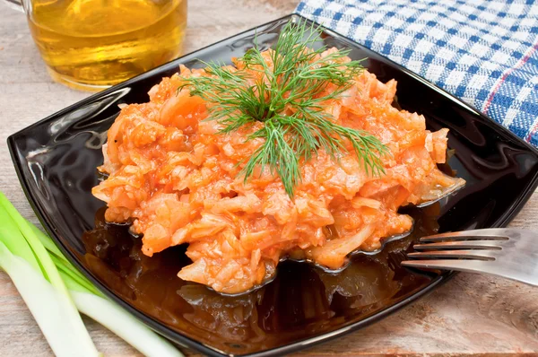 Braised cabbage in a bowl on a wooden table — Stock Photo, Image