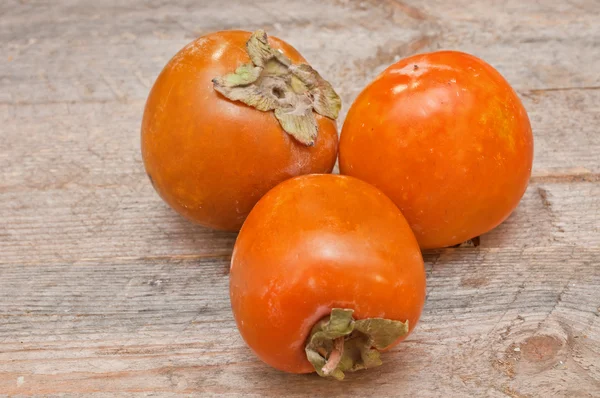 Persimmon owoc na drewnianym stole — Zdjęcie stockowe