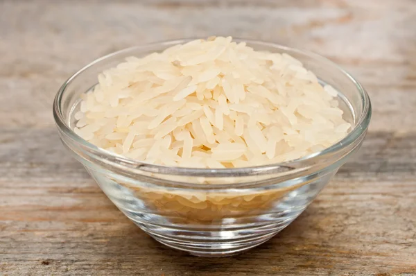 Rice cereal in a glass plate on wooden table — Stock Photo, Image