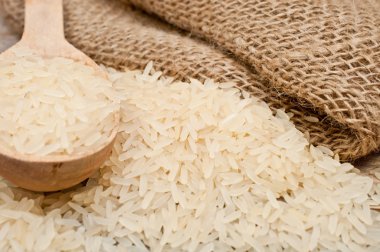 rice from the bag and wooden spoon clipart