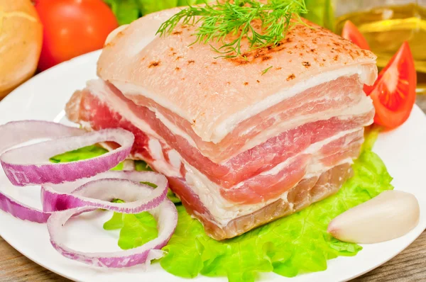 Smoked bacon on a plate with vegetables — Stock Photo, Image