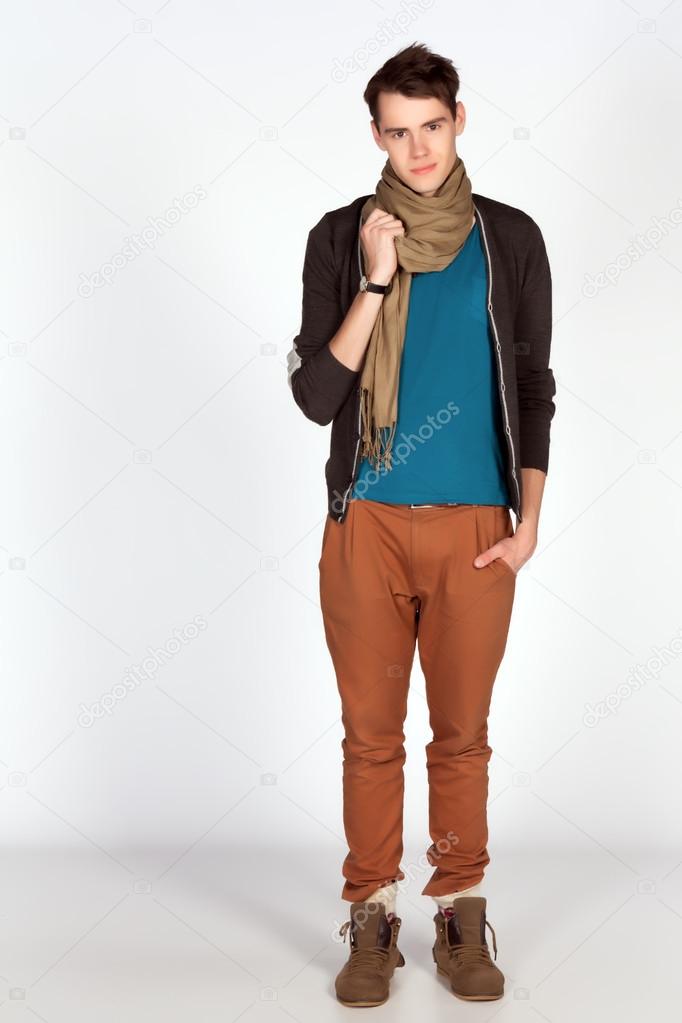 Young man in blue tanktop and scarf pose isolated on white background