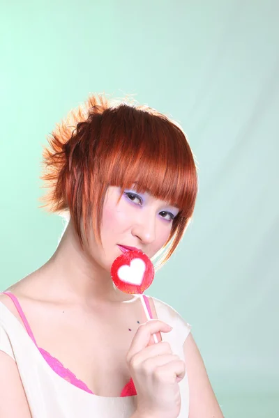 Girl in white dress with candy heart — Stock Photo, Image