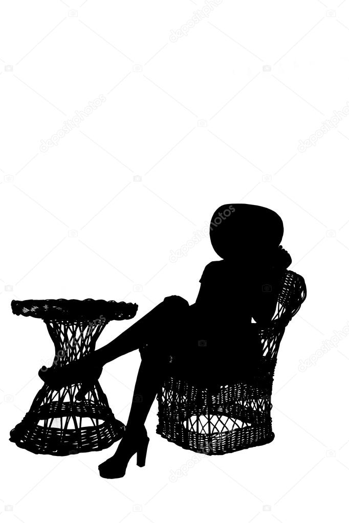 silhouette of girl sitting on wicker furniture