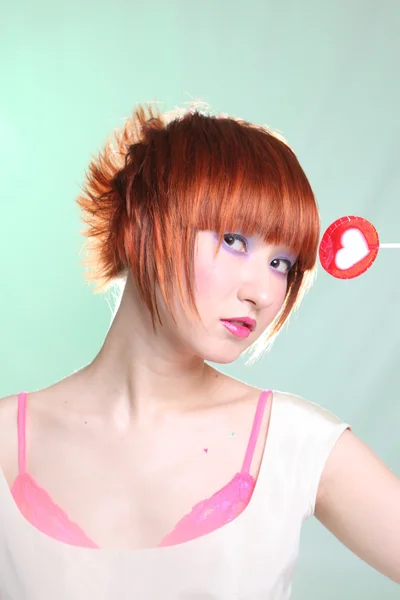 Portrait of woman with candy heart — Stock Photo, Image