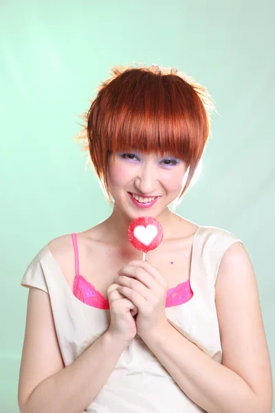 Portrait of woman with candy heart — Stock Photo, Image