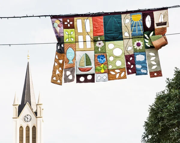 Church tower and decorative festive flags in Keszthely, Hungary, — Stock Photo, Image