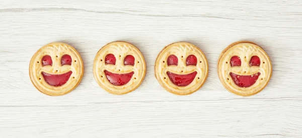 Four round biscuits smiling faces